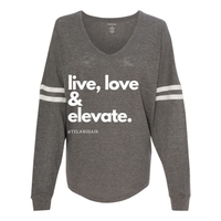 Thumbnail for Show your style and positive energy with the 'Live Love & Elevate' VarsiTee V-neck jersey. Designed with two white stripes on the sleeves, this trendy shirt combines comfort and flair. Made from a soft 60/40 cotton/polyester slub jersey blend, it offers a lightweight, breathable fit perfect for casual wear or layering. Whether you're out and about or lounging, the VarsiTee lets you live, love, and elevate your look with ease.